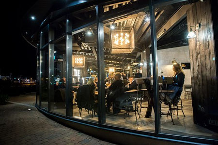A serene ambiance fills The Pod Cafe in Newport, with soft lighting creating a relaxed atmosphere
