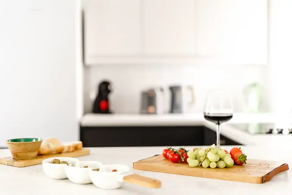 Kitchen countertop with assorted ingredients and utensils, ready for cooking and meal preparation