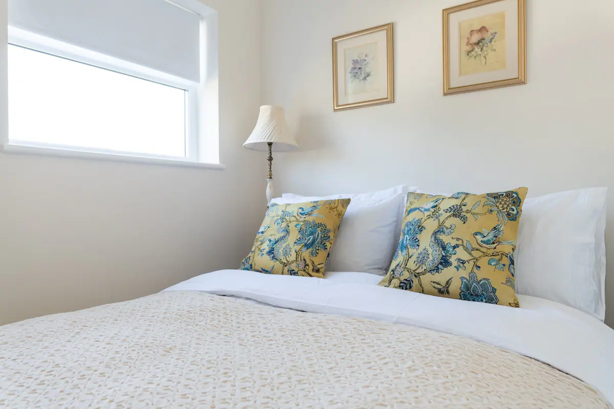 Bed in Pontcanna Pearl accommodation: A luxurious, inviting bed with plush pillows, crisp white linens