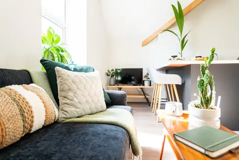 Contemporary living room with stylish furniture, vibrant decor, and a warm, inviting ambiance