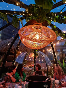 A cozy interior shot of The Pod Cafe in Newport, illuminated by warm pendant lights, creating a welcoming and inviting atmosphere