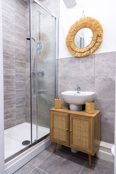Modern bathroom featuring sleek fixtures, clean lines, and minimalist design, with neutral tones and strategic lighting, creating a contemporary and inviting space