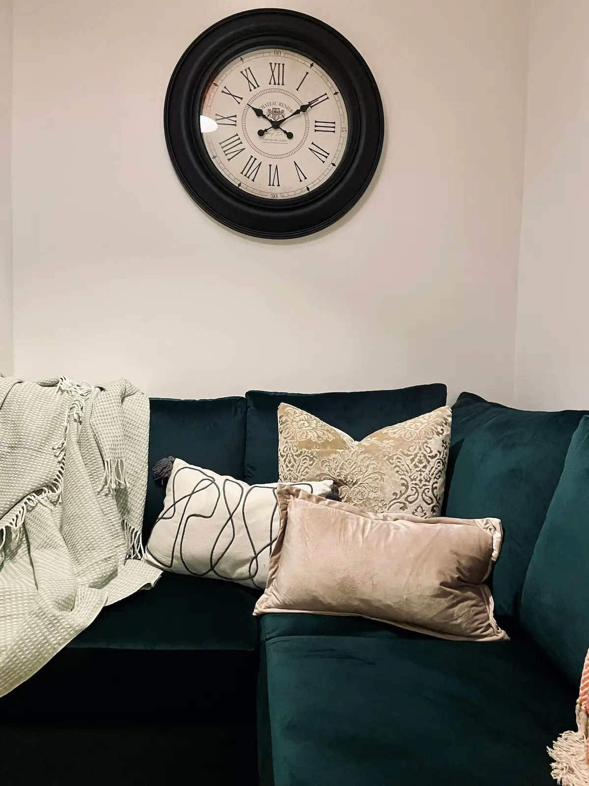 Image showing a green couch in the living room of Kensington Place, offering a cozy and inviting seating area