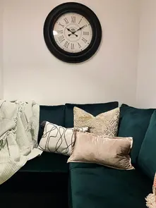 Image showing a green couch in the living room of Kensington Place, offering a cozy and inviting seating area