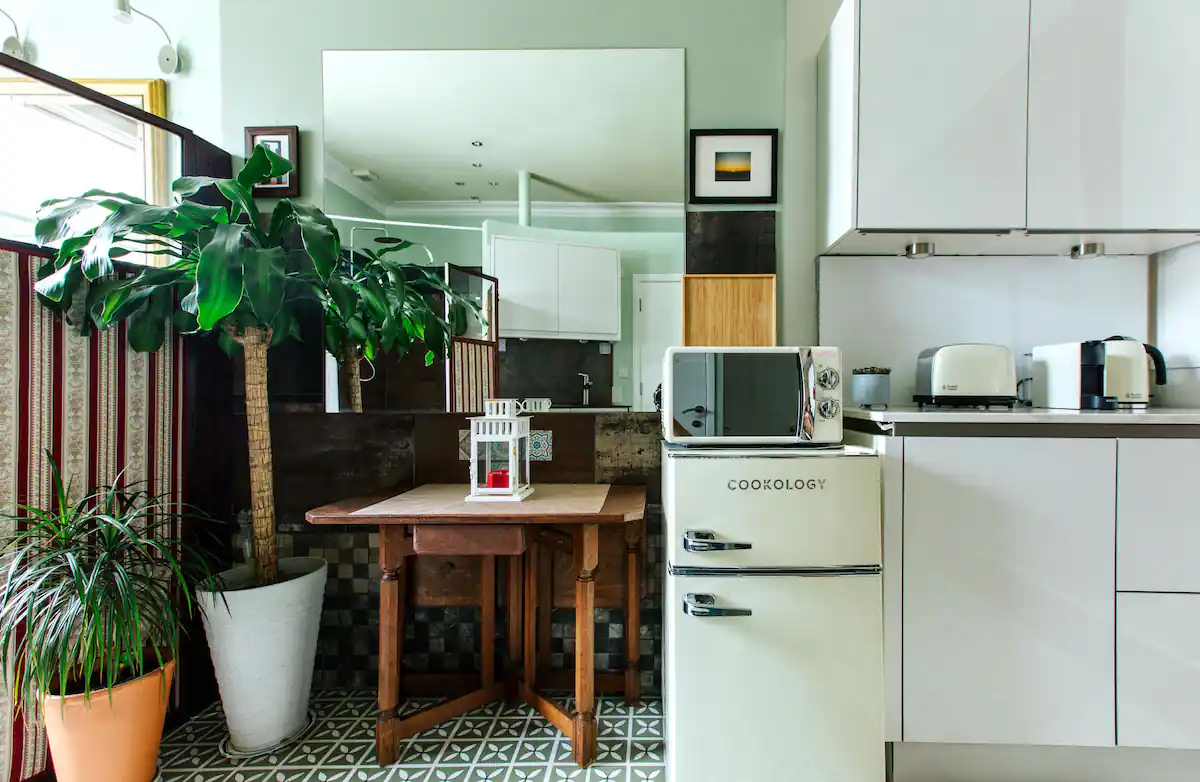 Cozy kitchen space with a vintage feel, equipped with modern appliances, in The Suite, a Victorian apartment in Cardiff
