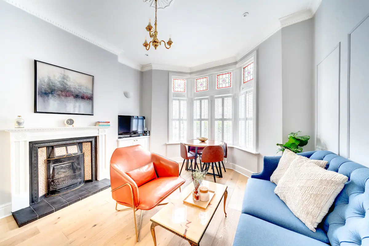 spacious and elegantly furnished area featuring a comfortable sofa, stylish armchairs, and a coffee table adorned with decorative accents