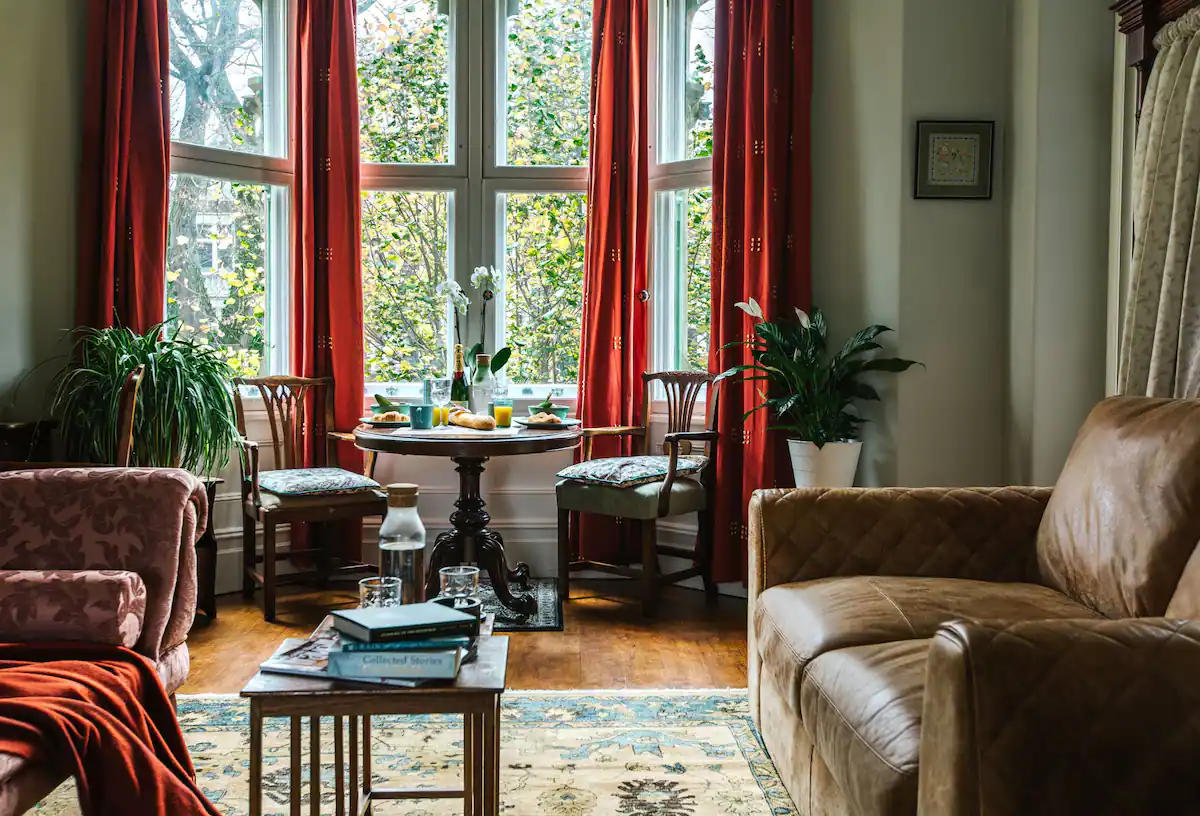 Cozy living room with traditional decor and historical charm, featuring comfortable seating and antique furnishings