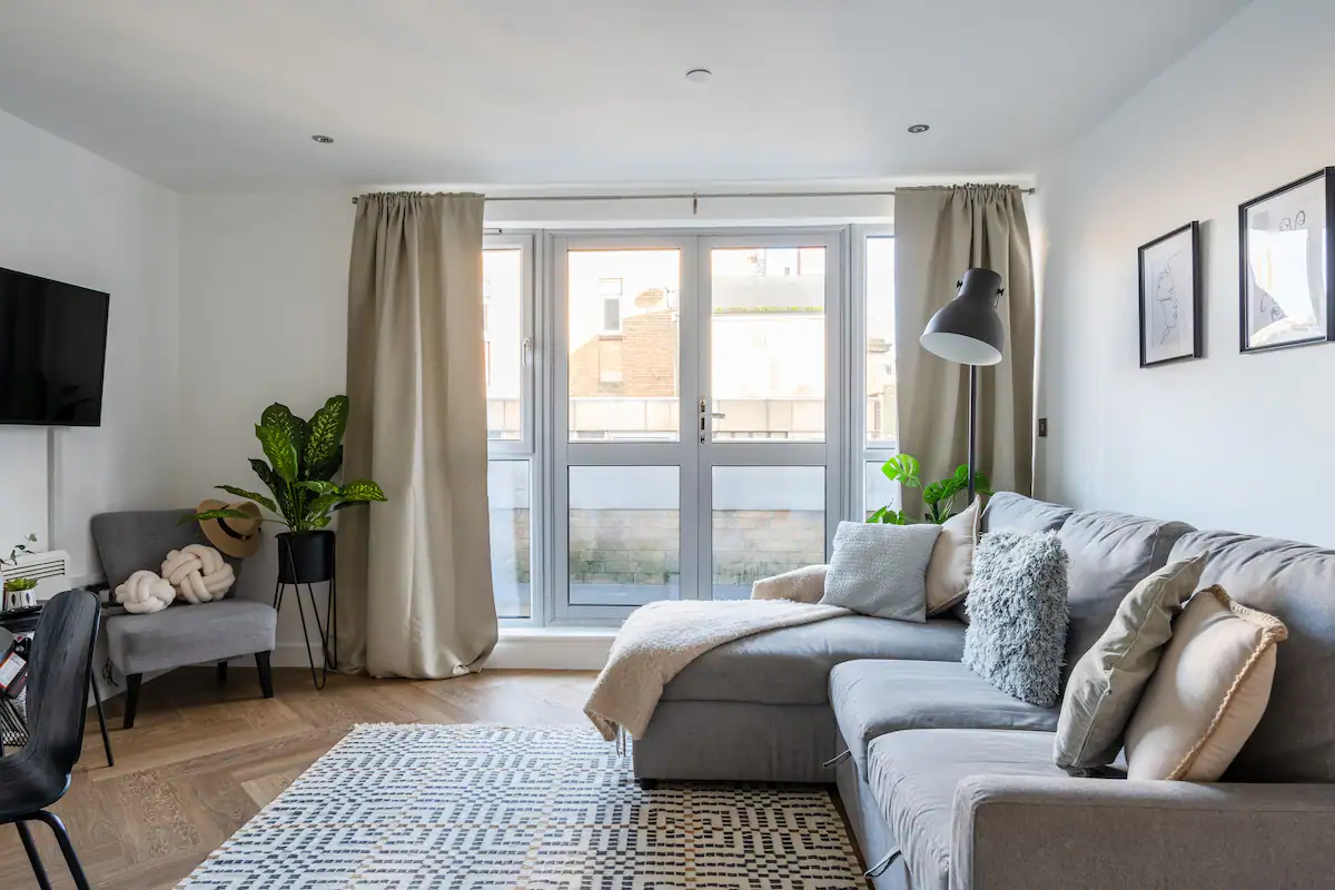 Comfortable sofa in the living room of Marsh House, Bristol, surrounded by tasteful decor and illuminated by natural light, offering a cozy spot for relaxation and lounging