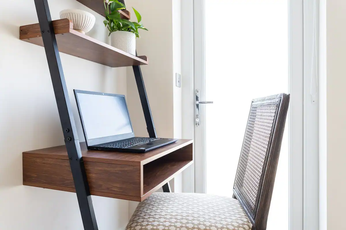 AirFreedom workspace: A modern desk setup with a laptop, ergonomic chair, and stylish decor, offering a comfortable environment for productivity