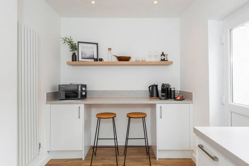Kitchen area in AirFreedom accommodation featuring a countertop with two stools for dining or casual seating