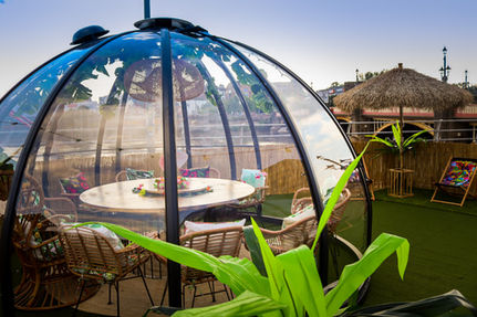 Interior of The Pod Cafe in Newport, featuring cozy seating, wooden tables, and a relaxed ambiance with soft lighting