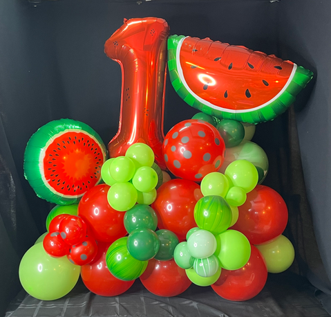 1st Birthday display in red and green with watermelon balloons
