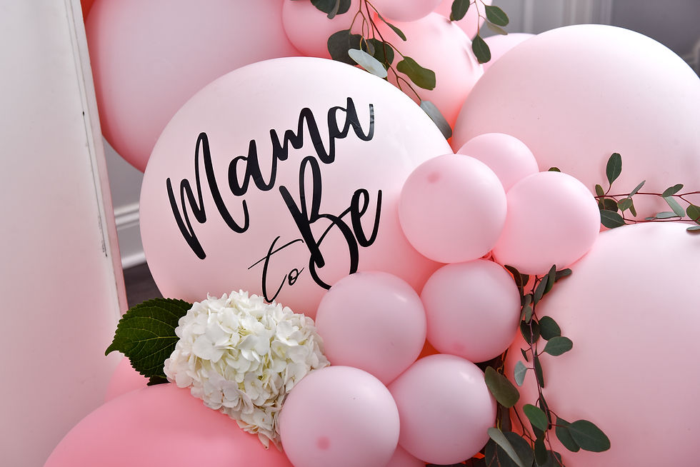 Pink balloon cluster with a large 'Mama to Be' balloon in elegant cursive