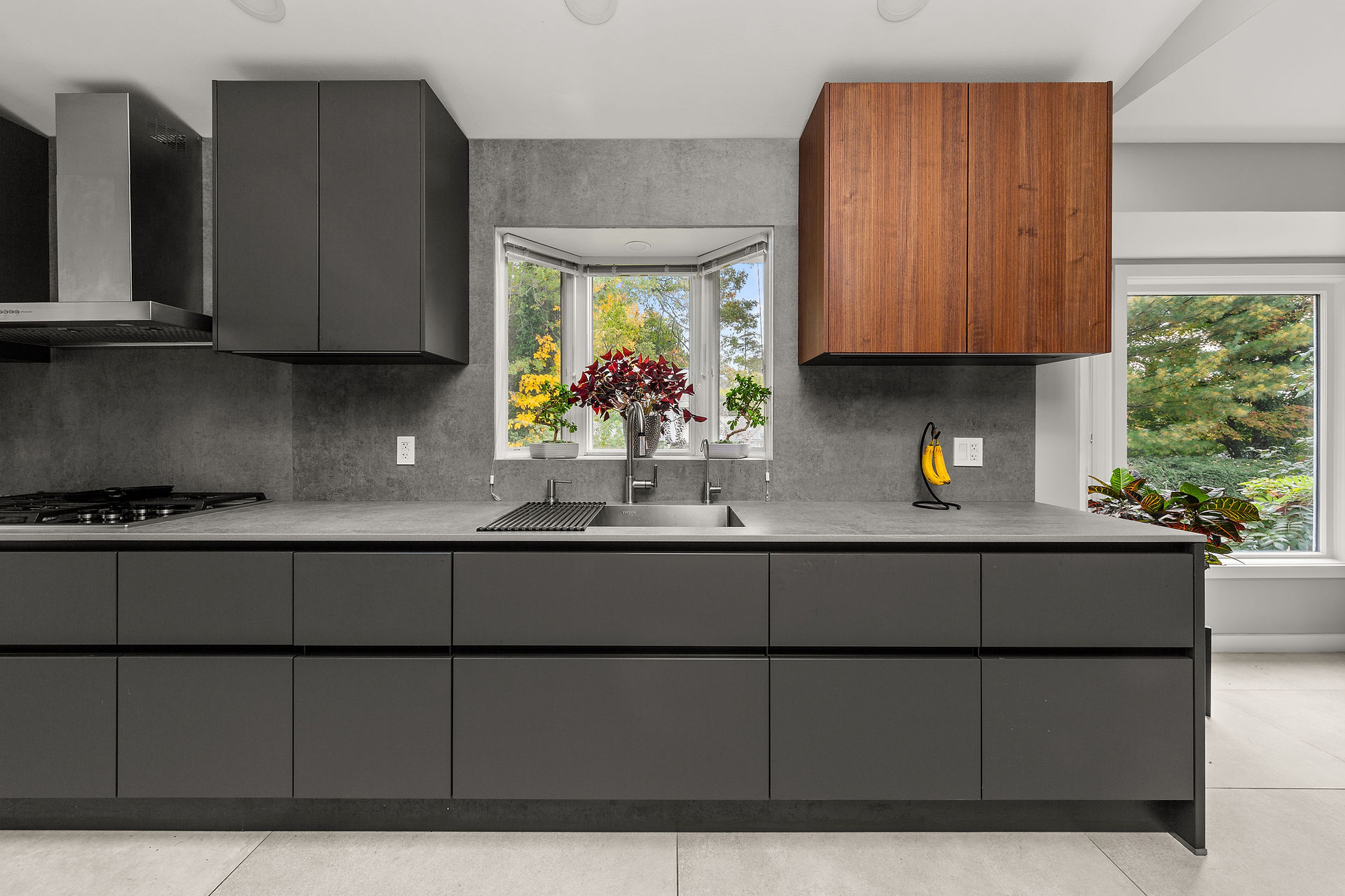 Finished minimalist kitchen showing handleless cabinetry and integrated appliances.