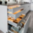 Glass-front kitchen wall units with backlighting and open shelving