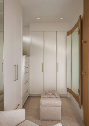 A Bright Ensuite closet with soft white custom cabinets