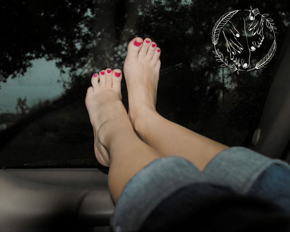 Tori posing her feet on the dashboard of a car.