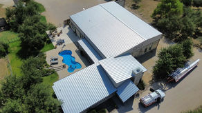 Hope Roofing completed a full standing seam metal roof replacement on this Uvalde property, upgrading the building from an existing R-panel system to a true standing seam roof for a cleaner, more premium finish.