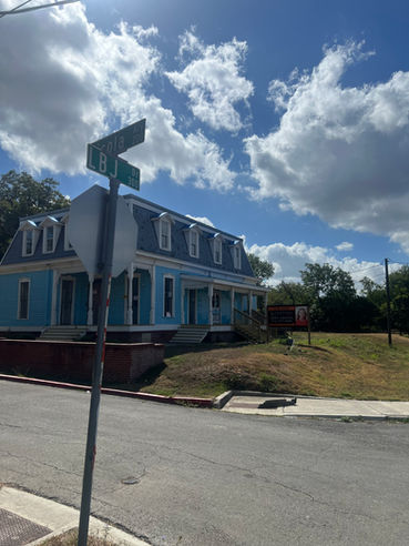 LBJ Drive street sign with blue commercial roofing project visible behind it