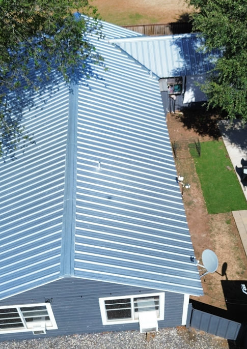 Aerial view of new galvanized metal roof on a home in Dilley, Texas