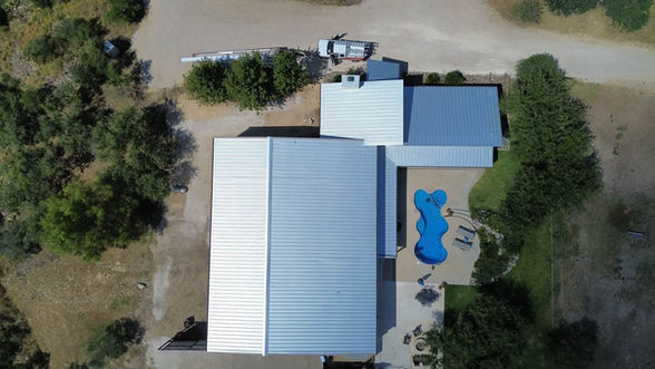 Hope Roofing upgraded this Uvalde building from R-panel to a true standing seam metal roofing system, totaling approximately 70 squares of U.S. mill steel construction.