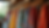 Eye-level view of a colorful bohemian dress hanging on a wooden rack