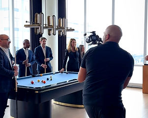 Humberto Ona III filming a corporate event in an office lounge, H Billi Media