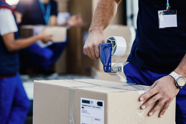 closeup-delivery-man-closing-carboard-box-with-tape-while-preparing-packages-shipment.jpg