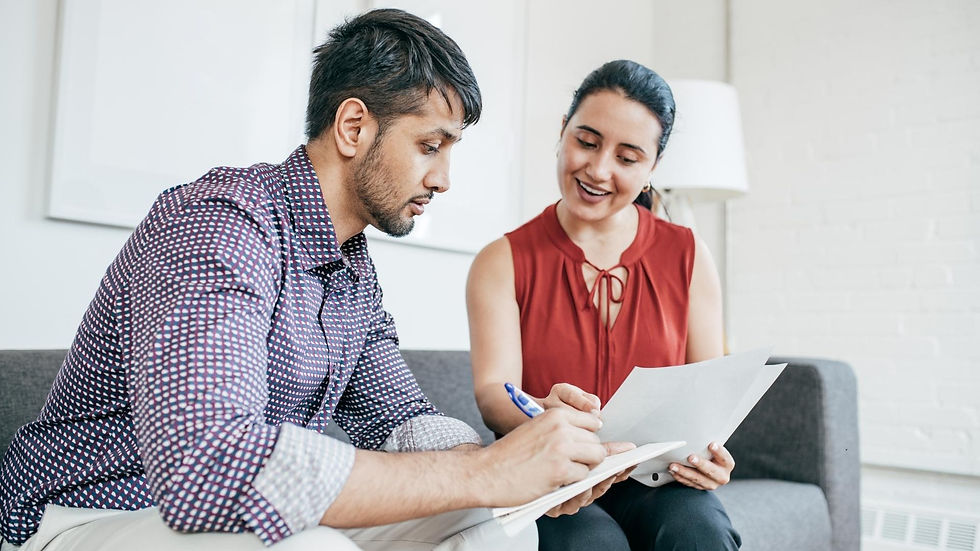 "A man and woman collaborating on documents in a cozy office environment, illustrating how IT solutions streamline guest-focused workflows."