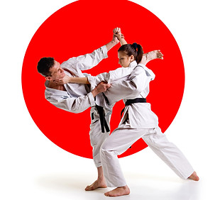 Martial arts master.Karate athletes on the background of the Japanese flag on a white bac