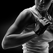 Black and white close up portrait of fitness athletic young woman in sports clothing showi