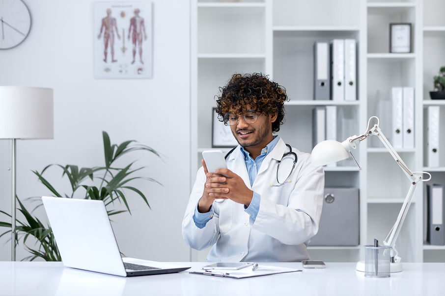 young-successful-hispanic-doctor-using-phone-man-2025-03-26-22-36-33-utc.jpg