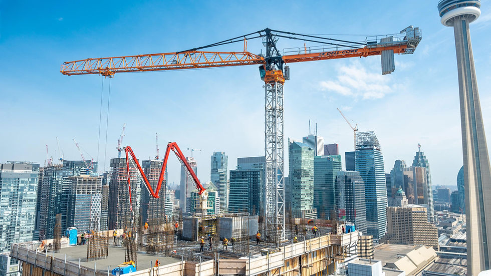 Construction workers on a high-rise job site in Toronto with cranes and skyline in the background