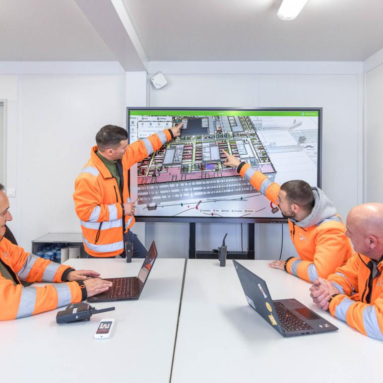 Project managers reviewing construction progress remotely using reality capture software