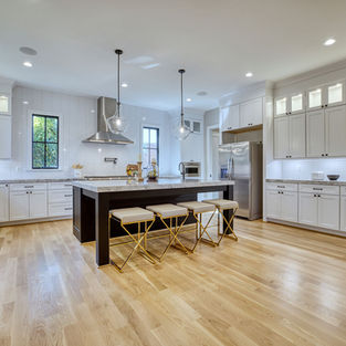 Open kitchen layout with black island and family-style dining.