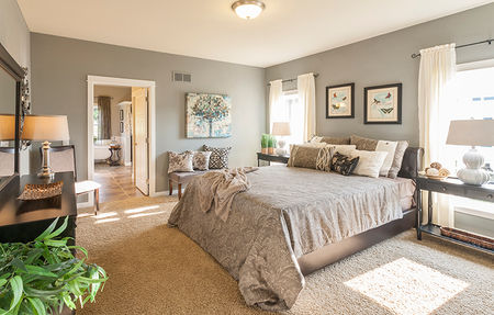 A large master bedroom with plush carpet and neutral decor in a custom modular homes pa build.