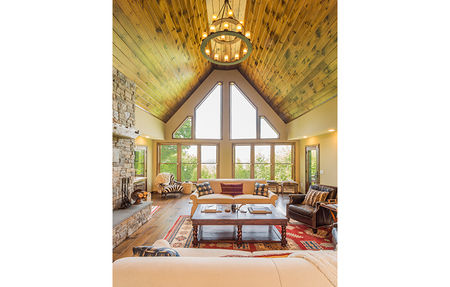 Interior view of a great room with a massive wall of windows highlighting the quality of our modular home floor plans.