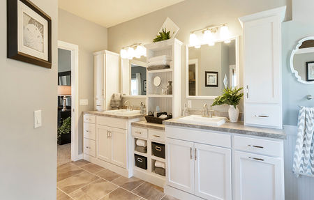 A large white double vanity in a master bathroom shown in modular home interior photos.