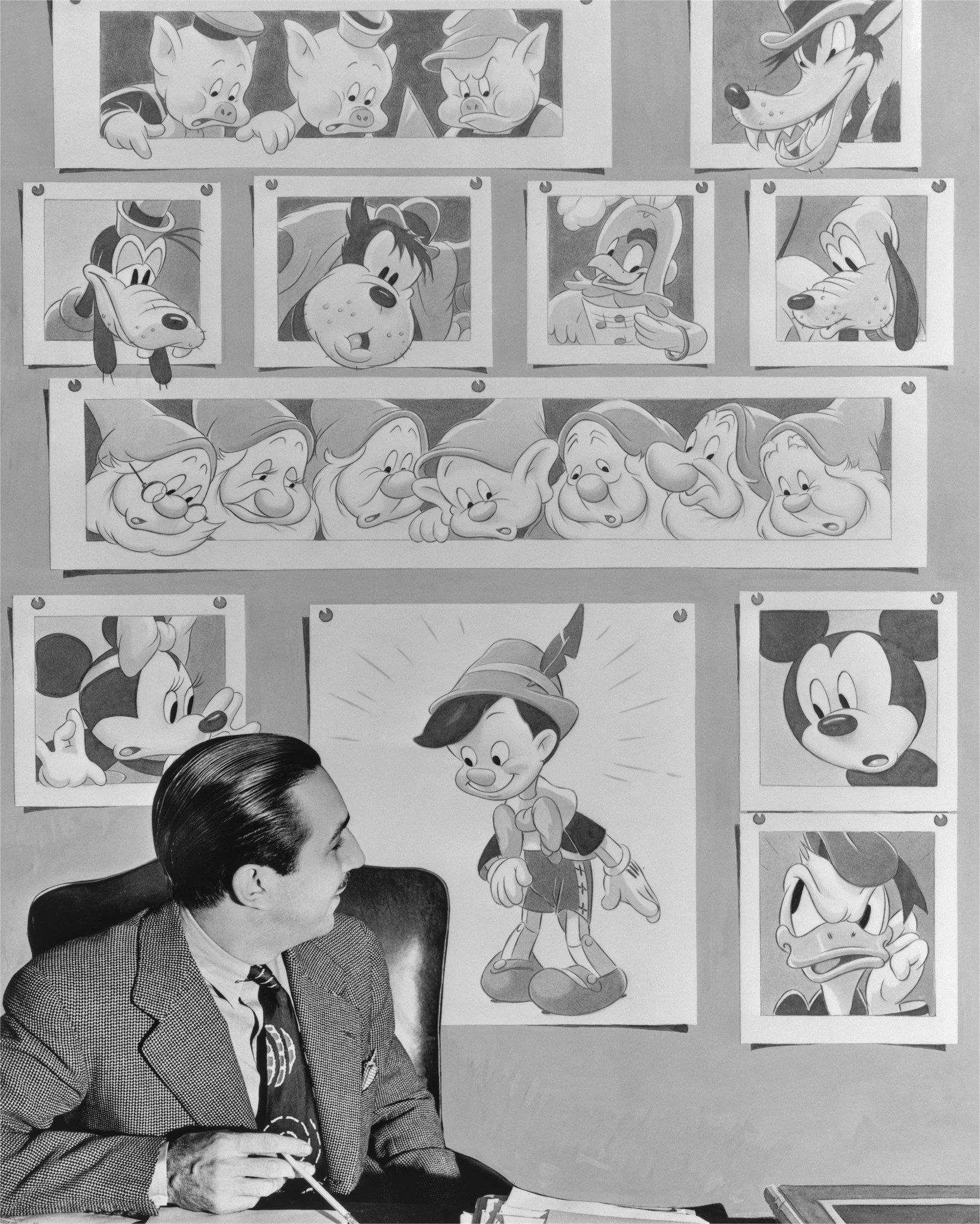 Walt Disney with drawings of Pinocchio and other classic Disney characters