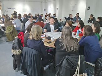 photo of people sitting around a table discussing ideas at a CIACIC workshop