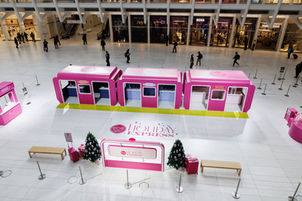 Custom fabricated pink train car installation for EOS Holiday Express pop-up at the Oculus in New York City built by Murmuration