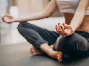 A closeup of a woman's hand while doing yoga