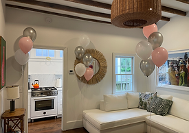 Elegant balloon installation for a graduation celebration at Casa Zoe’s Cottage property in the.erene courtyard in Charleston