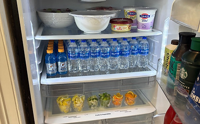 Fridge stocked with snacks, breakfast, fresh fruit, and drinks—perfect for families on quick Charleston trips