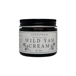 Black jar labeled "Wild Yam Cream" by Faith and Grace Organics, 2 oz. Simple white background, minimalistic design with floral accents.