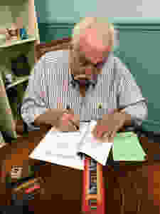 Paul hard at work, pen in hand
