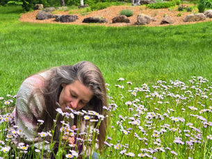 woman smelling wildflowers in spring ayurveda natural allergy relief