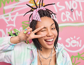 headshot-positive-cool-hipster-girl-makes-peace-gesture-eye-smiles-broadly-winks-eye-dress