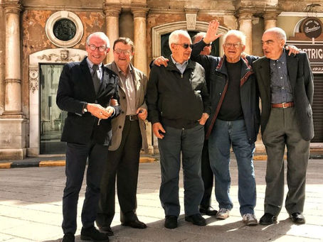 Italian locals chatting together on a street, showing everyday conversation and authentic Italian culture