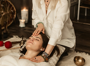 Therapist gently touching woman's forehe